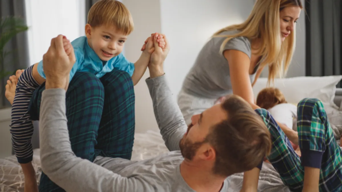 Parents and children celebrating with a high-five at home