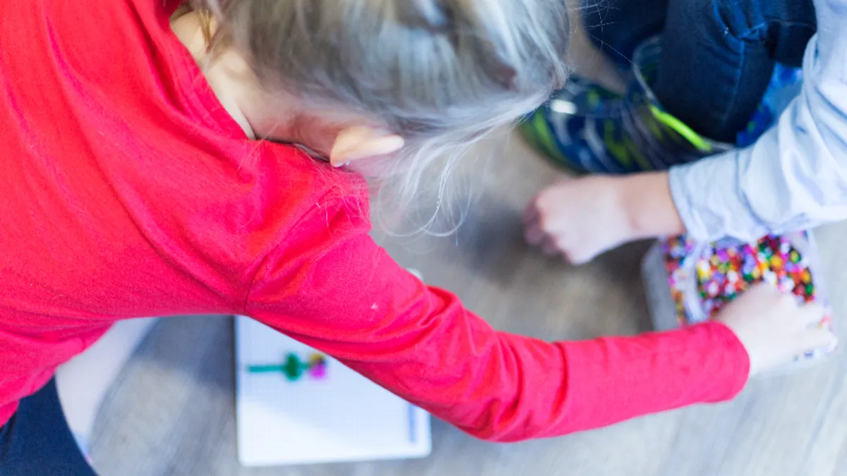 A young child engaged in a hands-on activity-based learning task