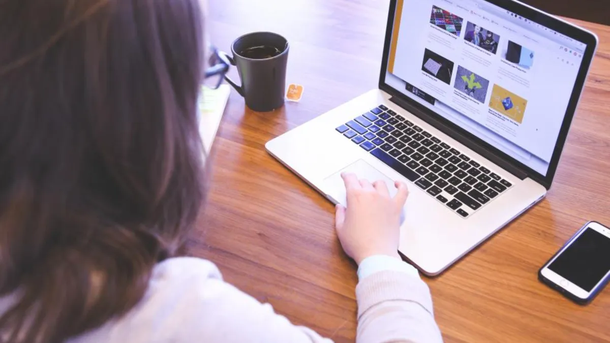 A first-time entrepreneur working on a laptop at a desk